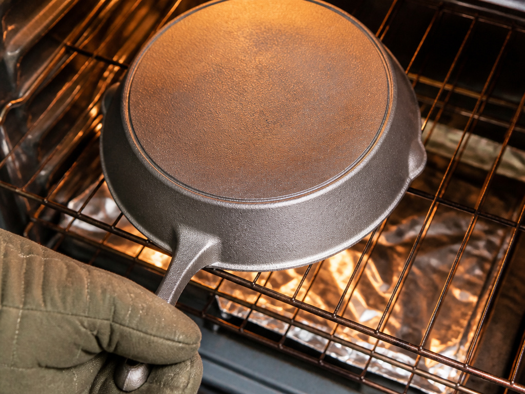 Bare cast iron skillet placed upside down in hot oven for re-seasoning.